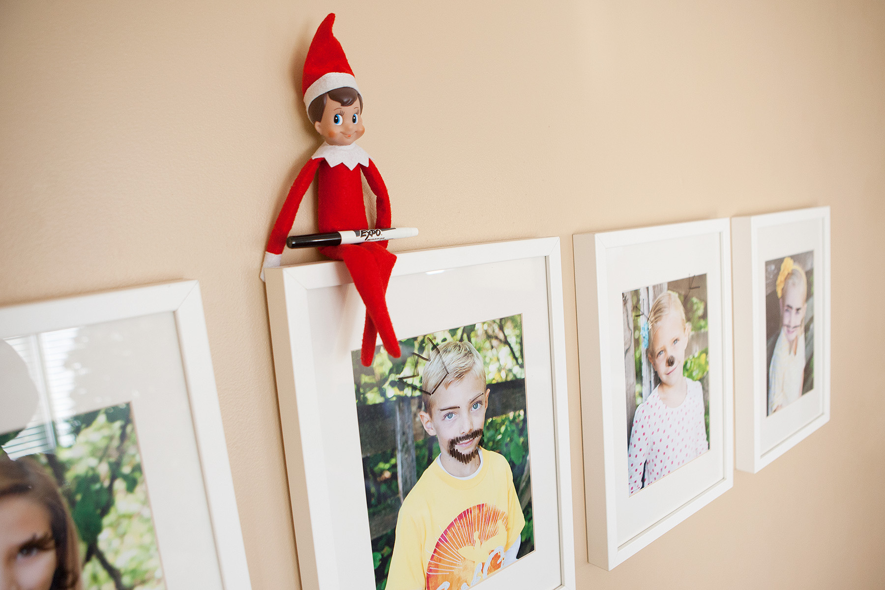 30 fun and unique Elf on the Shelf Ideas - Elf On the Shelf Doodling Faces on Family Pictures